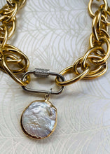 Load image into Gallery viewer, freshwater round Keshi Pearl set in a gold plated bezel pendant with handmade mixed metal statement chain necklace with micro pave' cubic zircons on a  carabiner locking clasp & white gold plating. sitting on peacock patterned pearl paper