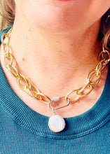 Load image into Gallery viewer, Genuine freshwater round Keshi Pearl set in a gold plated bezel pendant with handmade mixed metal statement chain necklace with micro pave' cubic zircons on a  carabiner locking clasp & white gold plating. worn on a blonde haired model wearing a green tank