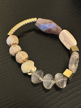 Load image into Gallery viewer, Beige coloured gemstones &amp; gold shell bead with gold textured tube bead bracelet on black background 