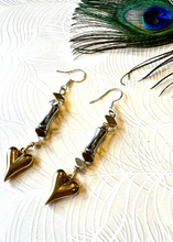 Load image into Gallery viewer, Gold heart two tone metal earrings on background paper with peacock feather