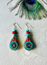 Load image into Gallery viewer, Turquoise gemstone &amp; red coral earrings with black &amp; gold teardrop feature bead &amp; 14ct gold filled ear hooks on a peacock paper background with a peacock feather above