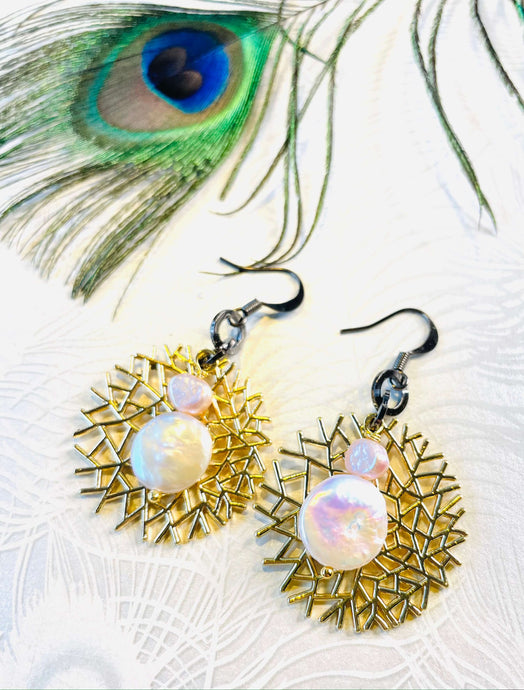 Genuine Keshi Pearl Earrings with peach freshwater pearls & small gold metal round birdsnest shape feature with gunmetal ear hook next to peacock feather