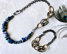 Load image into Gallery viewer, Blue Cloisonné feature bead with flower pattern, Lapis Lazuli gemstones &amp; blue Czech crystal beads on a gunmetal &amp; gold handcrafted adjustable statement chain with