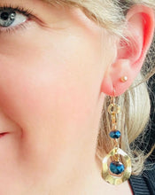Load image into Gallery viewer, Bright blue Czech crystal beads Earrings with textured gold toned metal wavy circle &amp; gold filled ear hooks on blonde haired model with blue eye