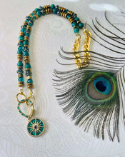 Load image into Gallery viewer, Green Malachite  necklace with 18ct gold plated crystal embellished pendant on white background with peacock feather