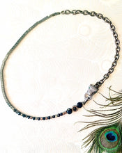 Load image into Gallery viewer, Black toned pave&#39; crystal embellished panther with green crystal eyes. Hematite Stone beads &amp; Czech crystal beaded necklace with gunmetal chain against a peacock feather background