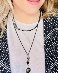 Black toned pave' crystal embellished panther with green crystal eyes. Hematite Stone beads & Czech crystal beaded necklace with gunmetal chain on a model with black & white jacket & long star pendant necklace
