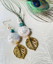 Load image into Gallery viewer, gold-leaf-charm-with-white-20mm-keshi-coin-pearl-turquoisr freshwater -pearl-hanging-from-silver-ear-hook-next-to-peacock-feather