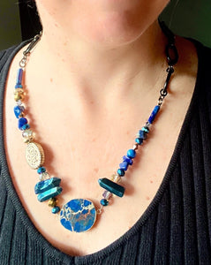 bright blue lapis lazuli and crystal statement necklace worn on neck