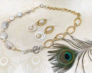 mixed shape white keshi pearl necklace with gold and silver chain with matching silver, gold and pearl earrings next to peacock feather 