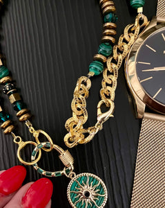 Green Malachite  necklace with 18ct gold plated crystal embellished pendant on black background with watch & red manicure
