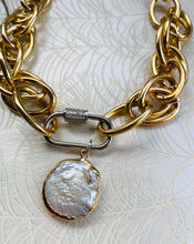 Load image into Gallery viewer, freshwater round Keshi Pearl set in a gold plated bezel pendant with handmade mixed metal statement chain necklace with micro pave&#39; cubic zircons on a  carabiner locking clasp &amp; white gold plating. sitting on peacock patterned pearl paper 