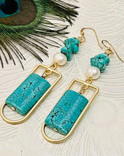 Load image into Gallery viewer, Turquoise pillow shape stone with gold frame  freshwater pearl and turquoise earring against a light background with a peacock feather
