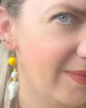Load image into Gallery viewer, Iridescent white enamel leaf cloissone earrings with freshwater pearl, yellow faceted crystal &amp; 14ct gold filled ear hooks worn on ear by blonde haired blue eyed model